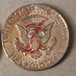 2024 Kennedy half dollar missing clad layer error showing exposed copper core on one side